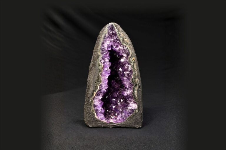 A small amethyst geode cathedral with an open crystal cavity