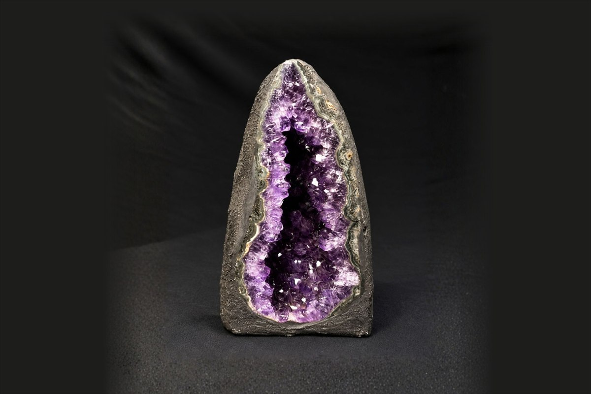 A small amethyst geode cathedral with an open crystal cavity