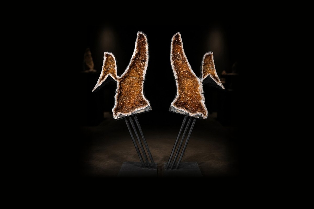 A matched pair of citrine angel wings on black steel stands