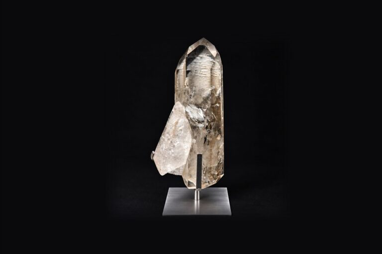 A smoky quartz point mounted on a brushed steel stand