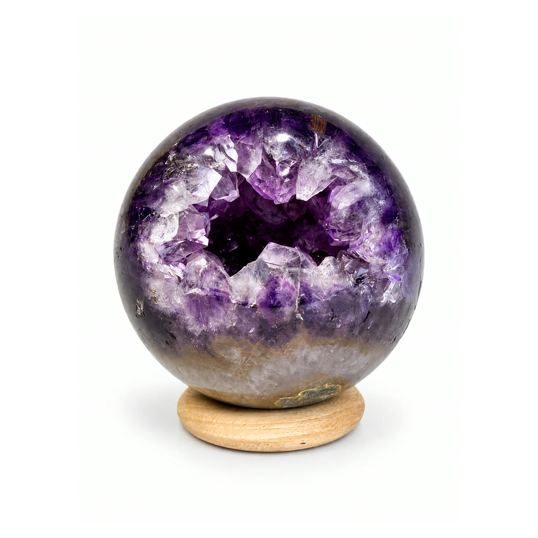 A polished amethyst sphere opened around a natural crystal pocket