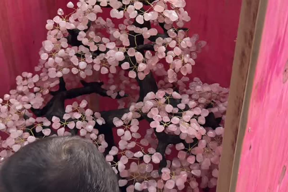 A CS Minerals worker crating a large rose quartz gemstone tree on an amethyst base for export, the way a Brazilian crystal supplier packs large pieces
