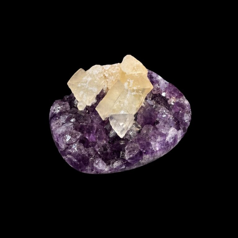 Amethyst cluster with golden calcite crystals on top, photographed on a black background