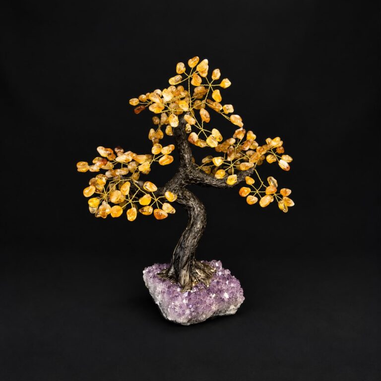 Decorative golden gemstone tree on an amethyst cluster base
