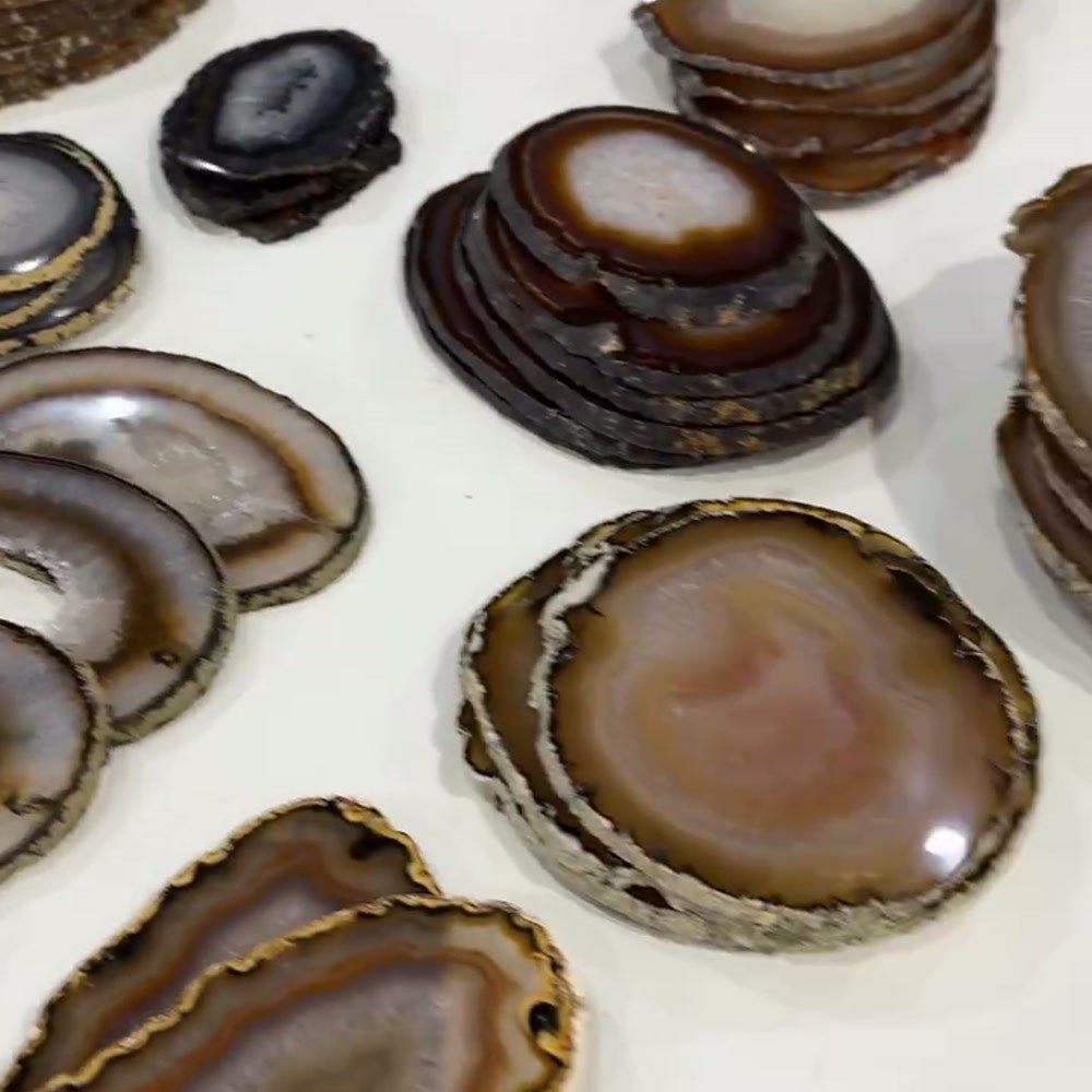 Polished Brazilian agate slices in warm brown and amber tones, a popular line for crystal wholesale UK buyers