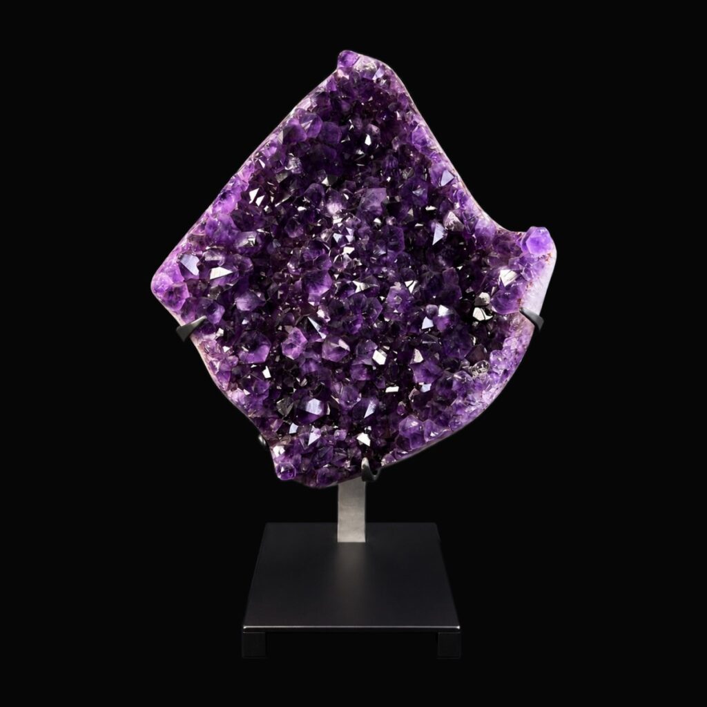 Amethyst cluster on a display stand