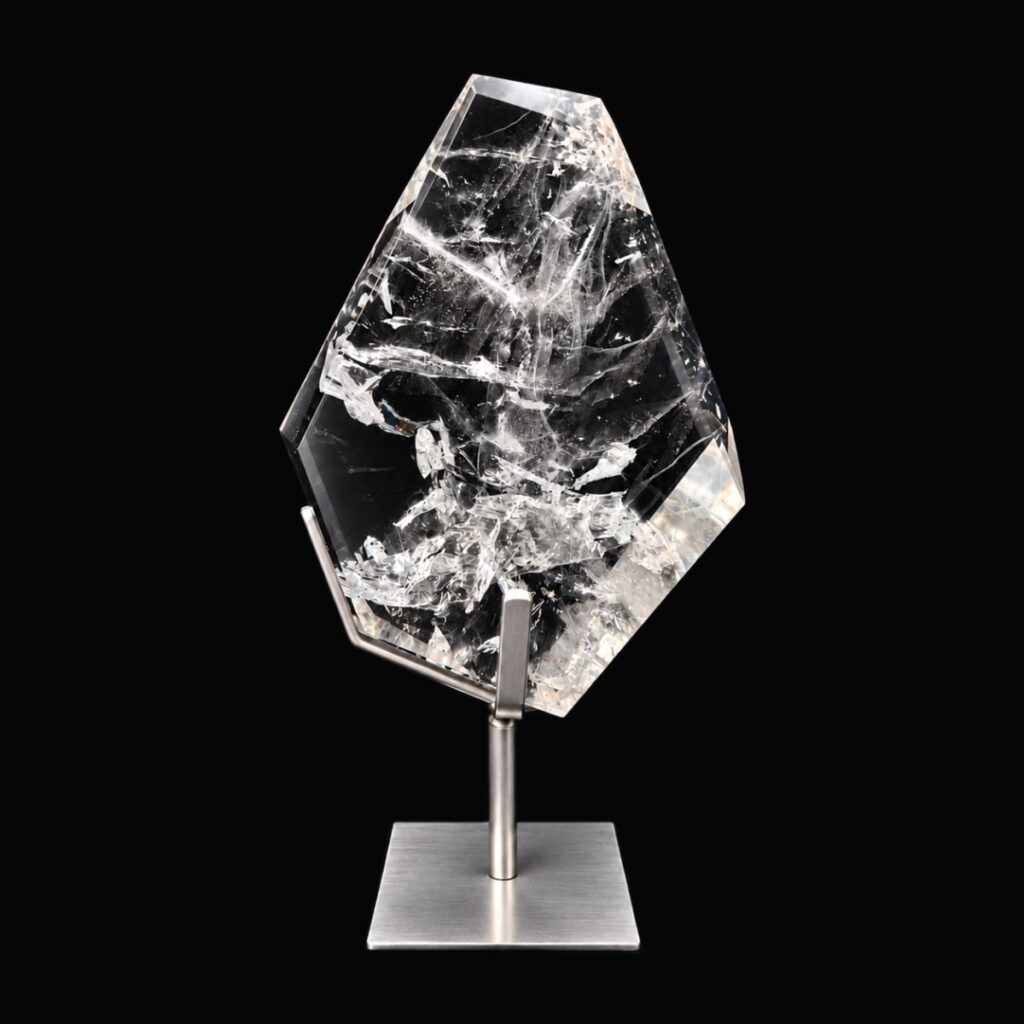 Polished clear quartz freeform on a steel stand