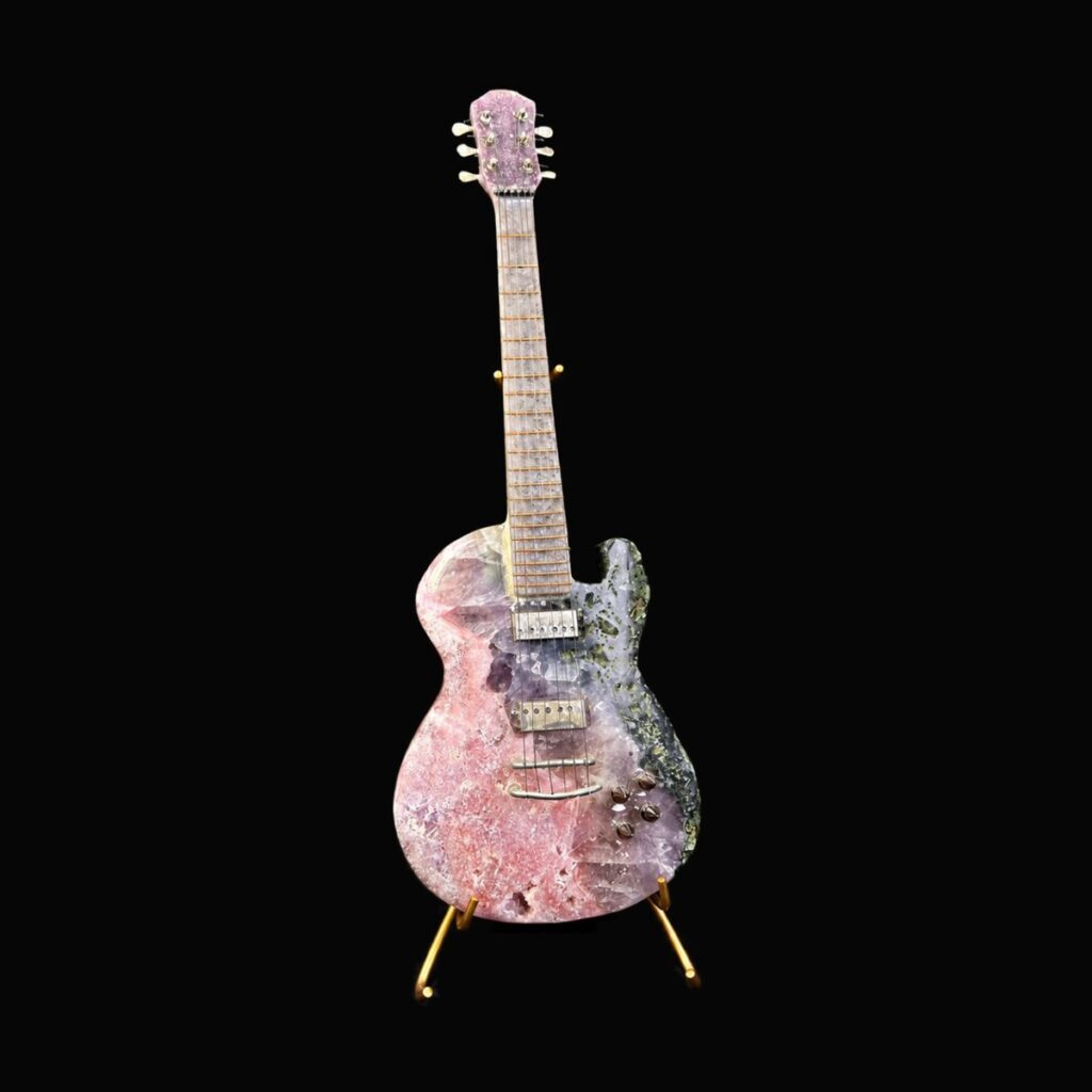 Crystal guitar sculpture on a gold stand