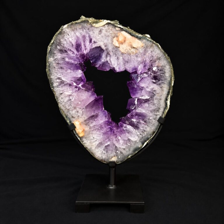 Amethyst geode slice with deep purple crystals and an open centre, mounted on a black metal stand